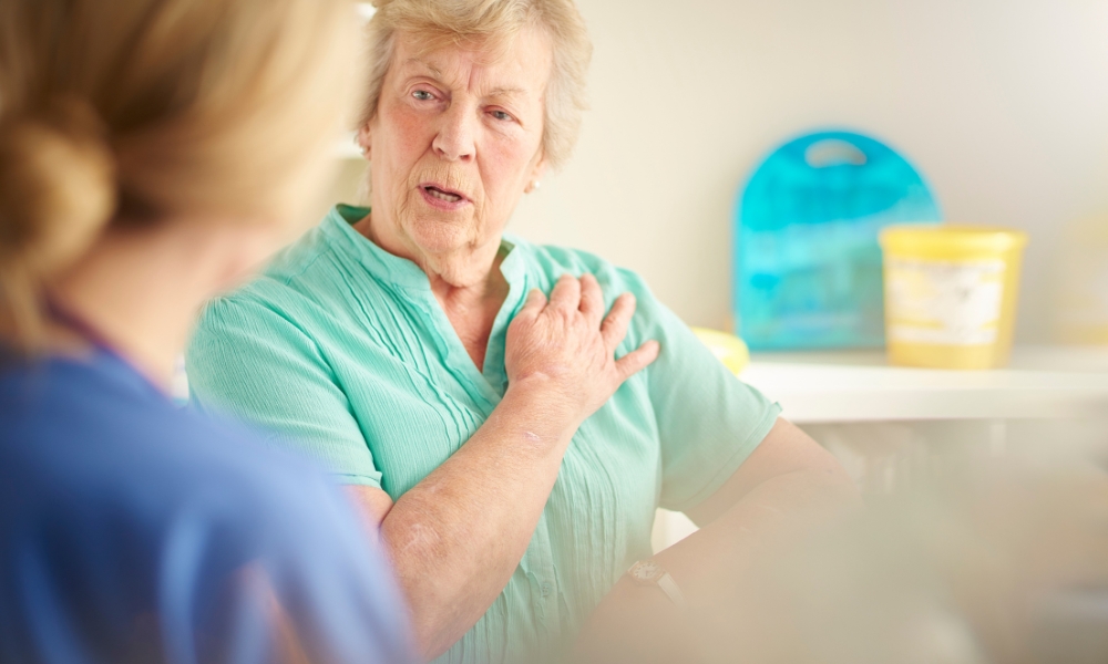 Patient experiencing left side chest pain while discussing symptoms with a healthcare provider