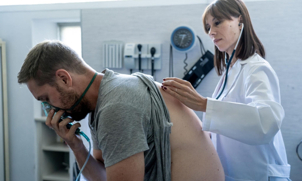 Doctor evaluating a patient experiencing shortness of breath during a medical consultation