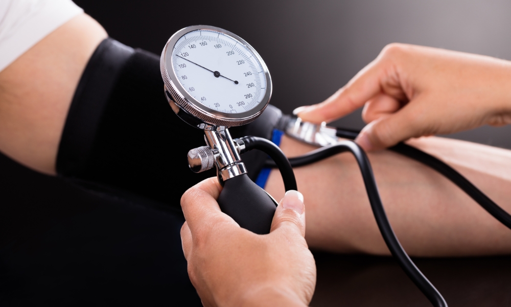 Doctor checking patient's blood pressure during a routine medical examination