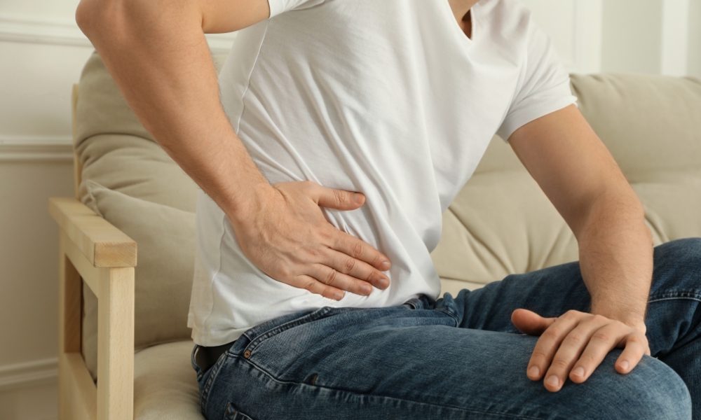 Doctor examining a patient experiencing lower right abdominal pain during a medical consultation